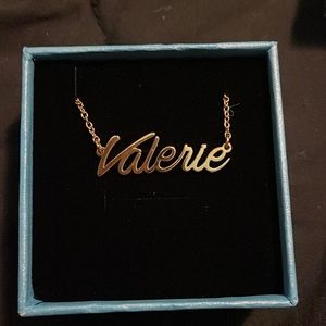 Gold colored name plate necklace. (Valerie)